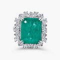 Green cocktail ring in sterling silver with an emerald-cut lab-created emerald alternative center stone and halo setting