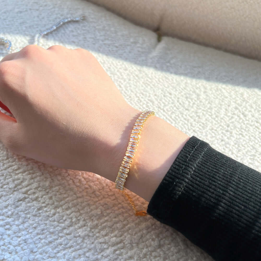 woman wearing gold emerald-cut cubic zirconia bracelet