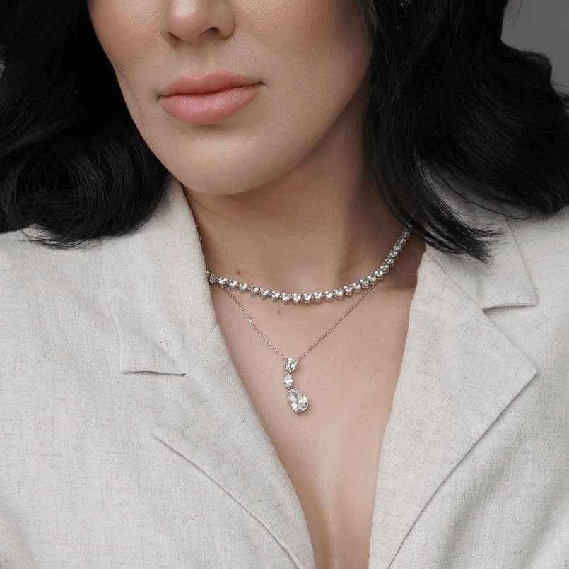 woman wearing heart, oval, and pear-shaped cubic zirconia necklace