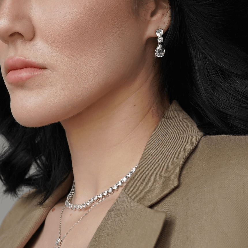 woman wearing heart, oval, and pear-shaped cubic zirconia earrings