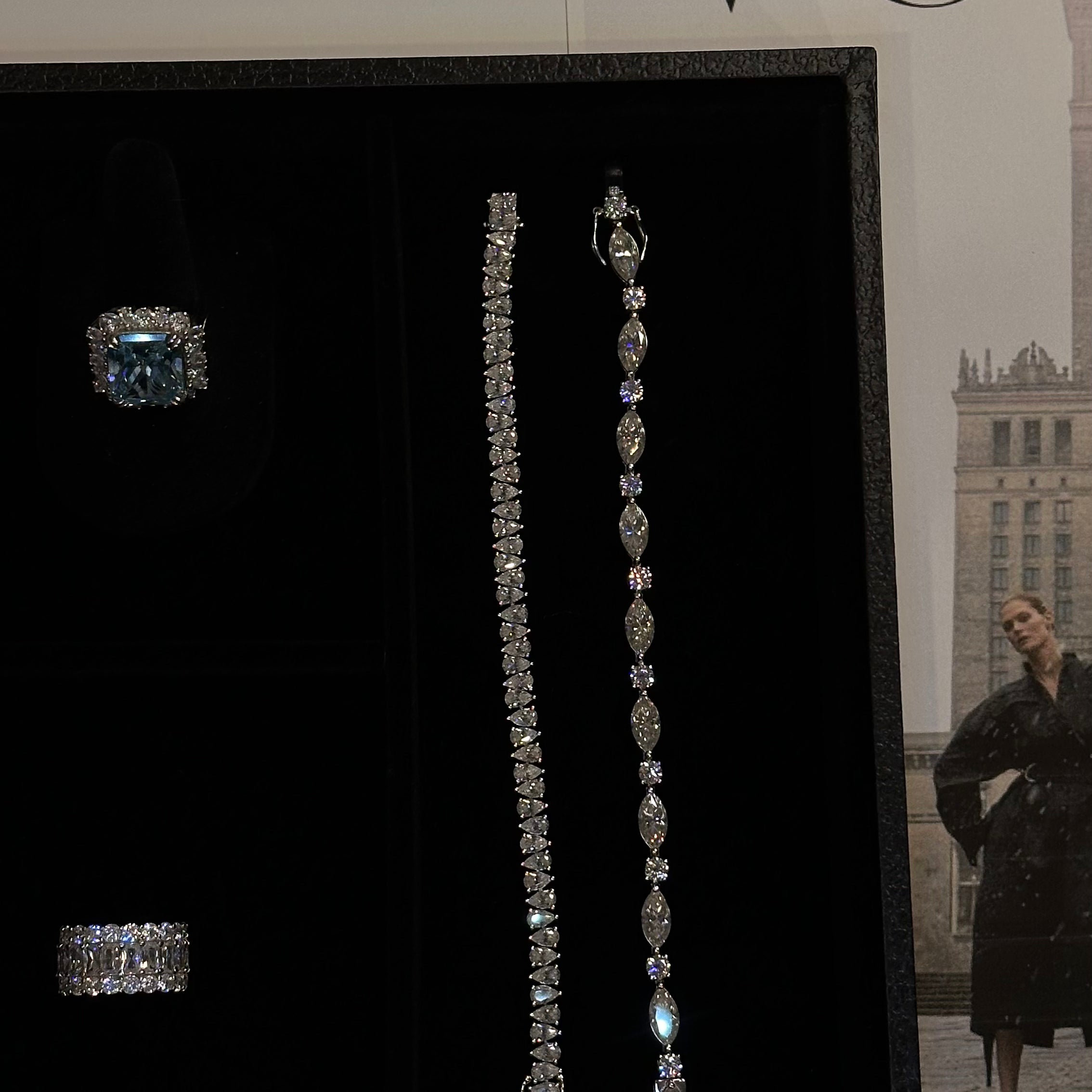 Diamond-free Jewelry by Viviana Halil including ring and earrings displayed on a black stand with 'VOGUE' magazine in the background.
