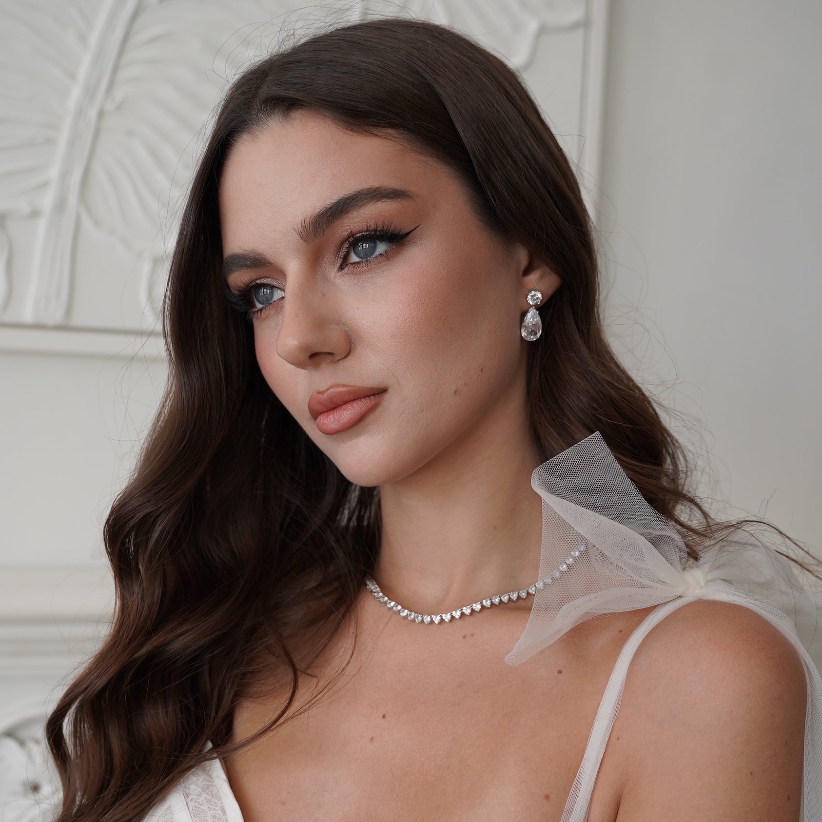 woman wearing cubic zirconia earrings and necklace