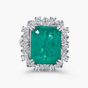 Green cocktail ring in sterling silver with an emerald-cut lab-created emerald alternative center stone and halo setting
