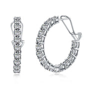 A pair of sterling silver hoop earrings encrusted with premium zirconia stones.
