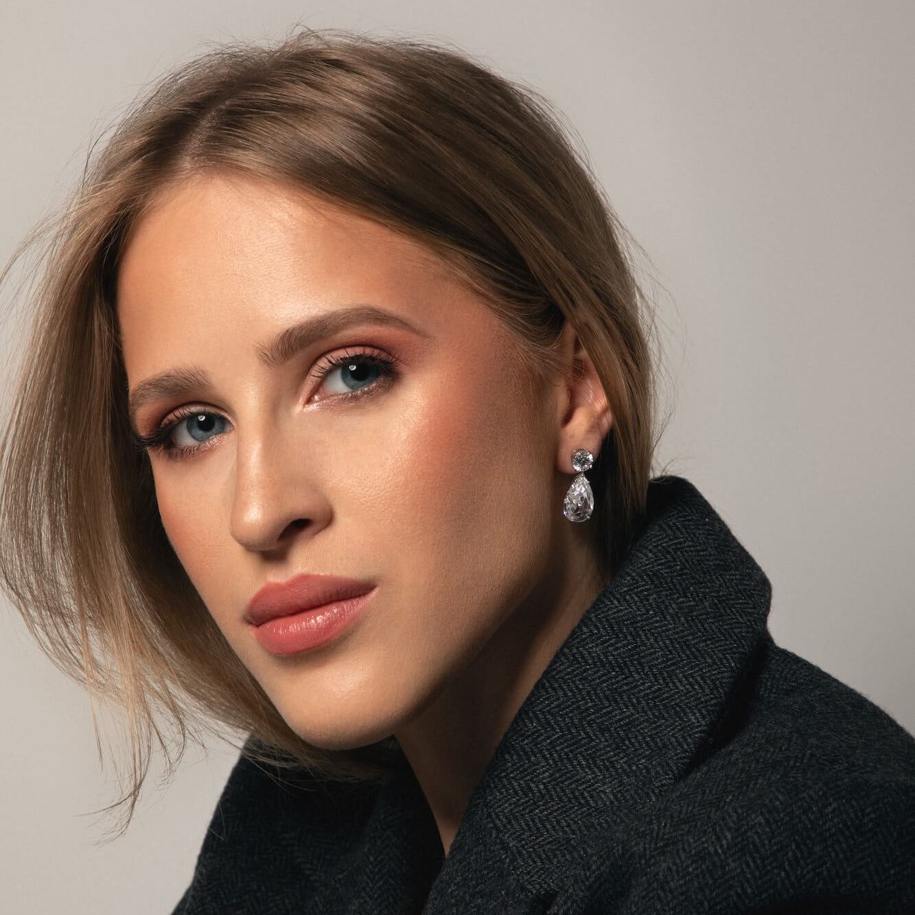 Model wearing The Le Bijou Earrings a dangle timeless earring diamond free by Viviana Halil in Beverly Hills.