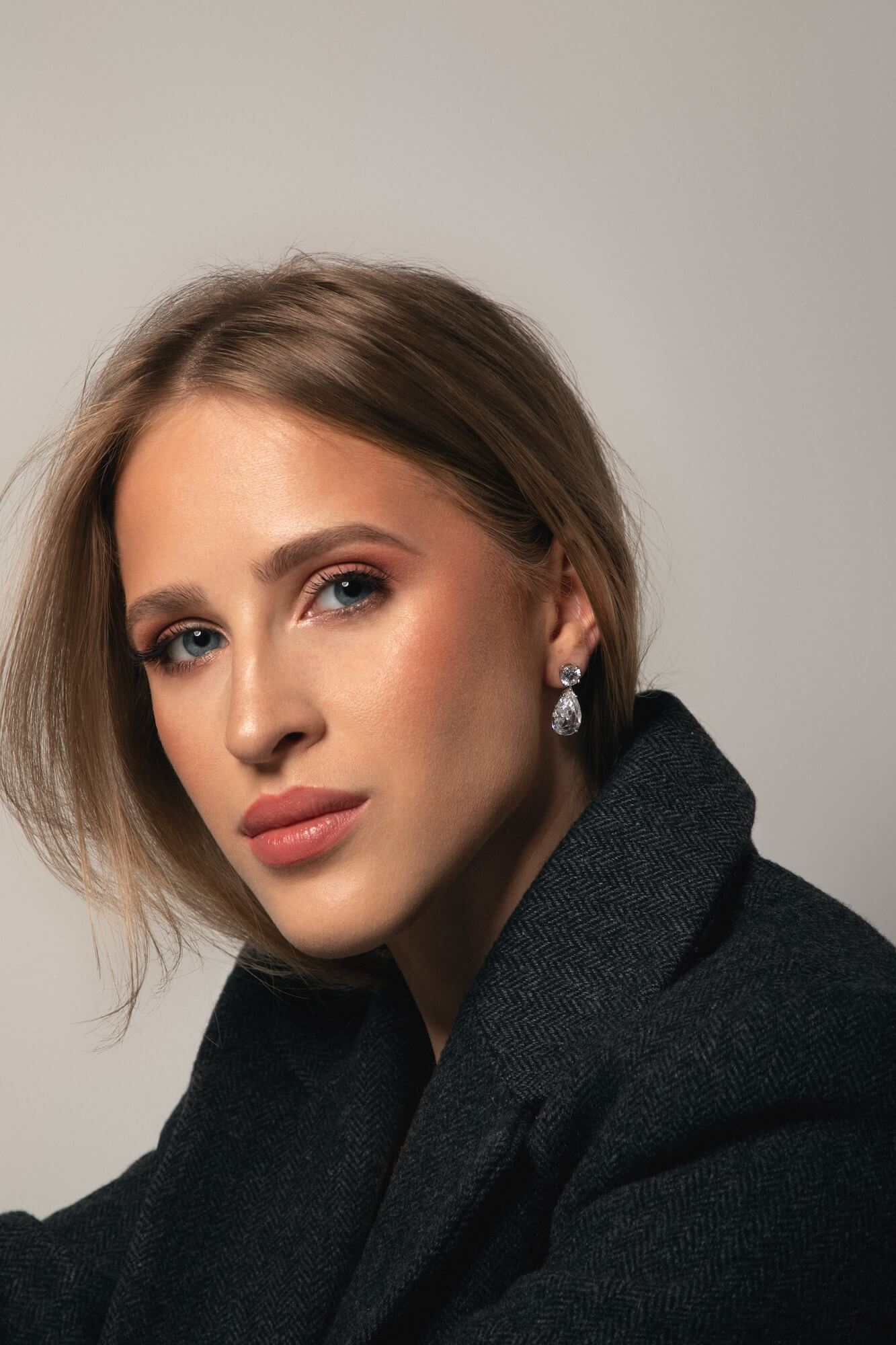 Model wearing The Le Bijou Earrings a dangle timeless earring diamond free by Viviana Halil in Beverly Hills.