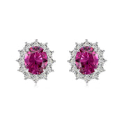 Close-up of The Lucia Studs featuring oval fuchsia center stone and halo brilliance by Viviana Halil.