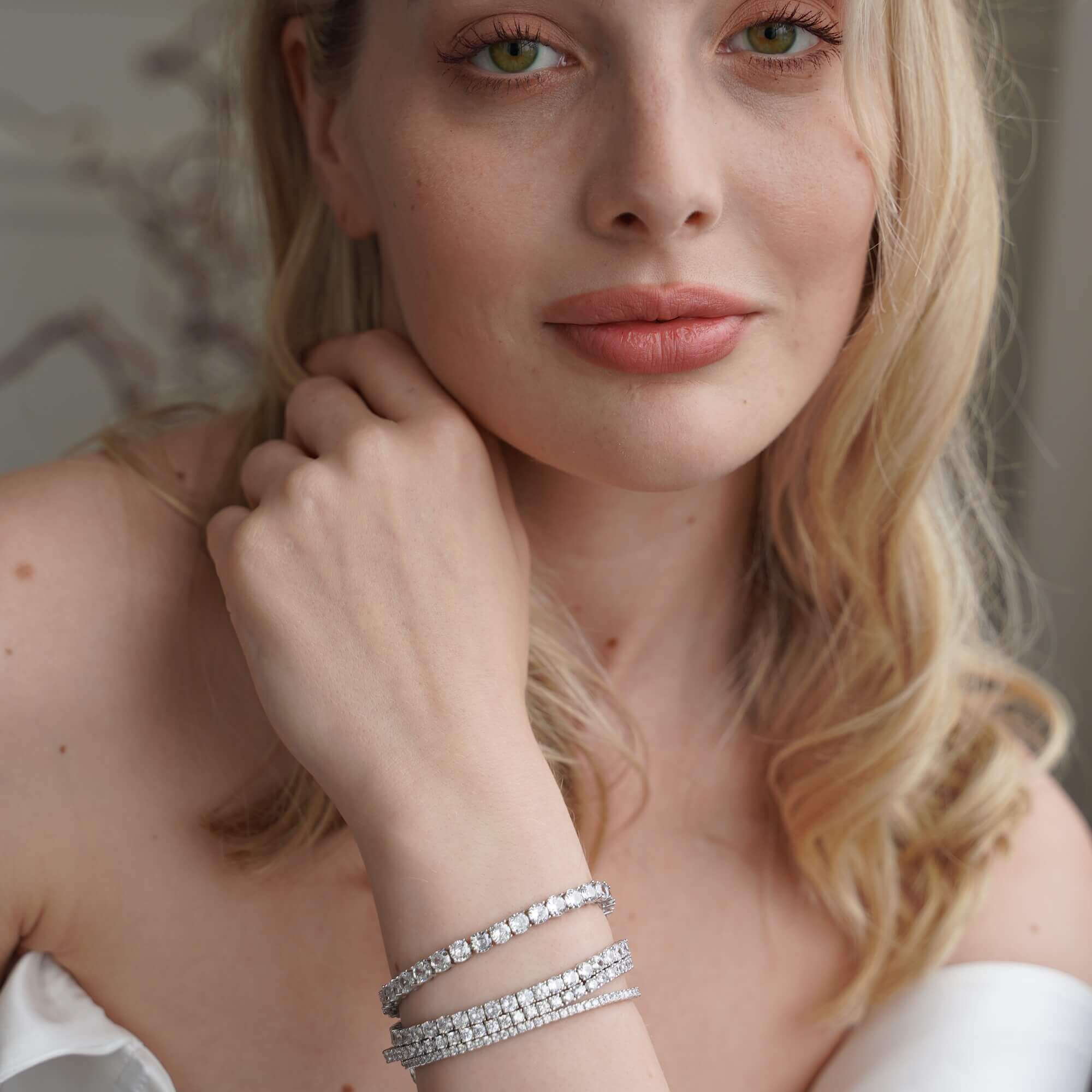 Viviana Halil diamond alternative tennis bracelet stack worn on wrist in natural lighting.