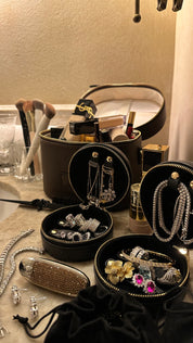 Viviana Halil jewelry displayed in travel cases on bathroom vanity. 