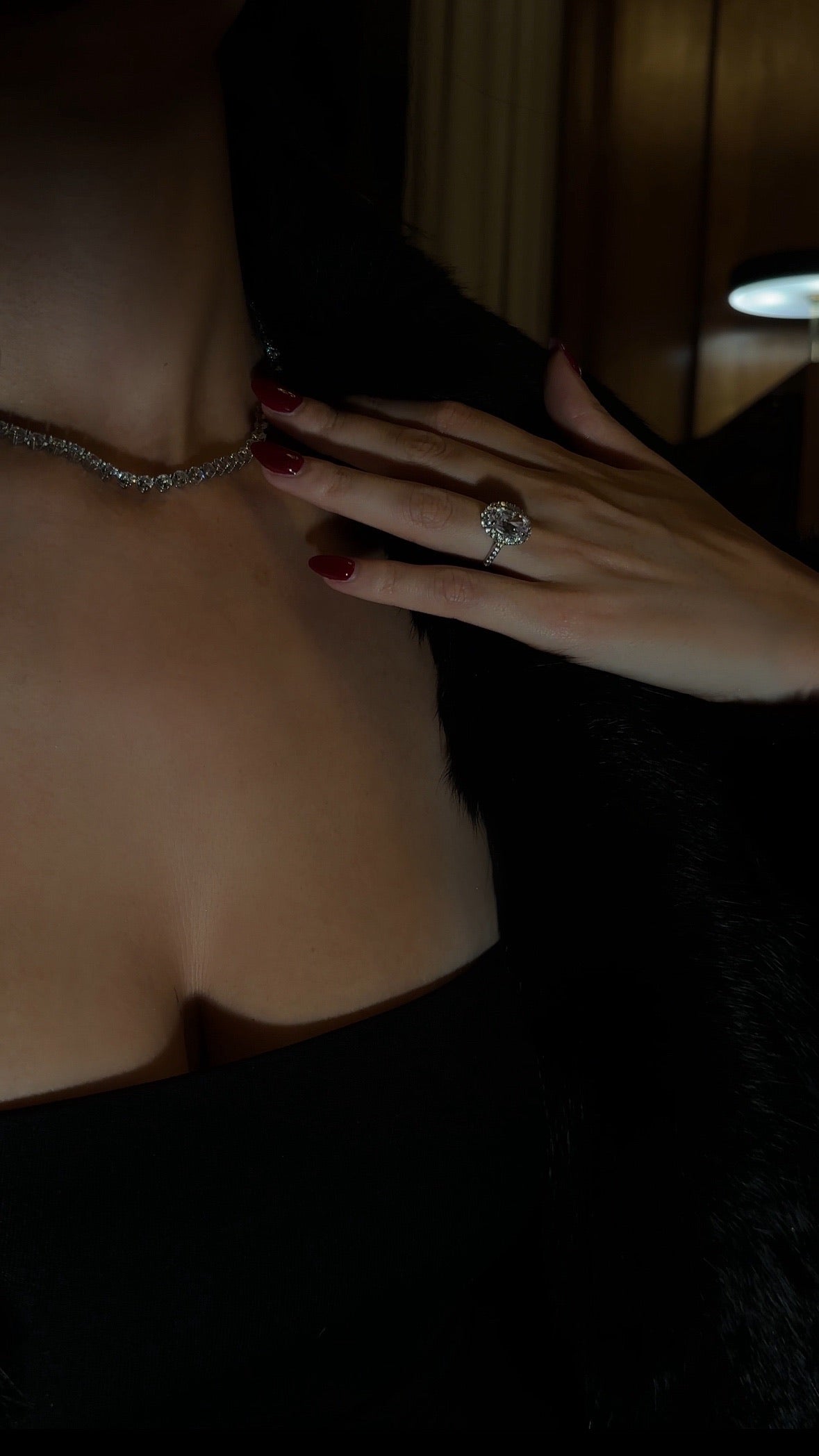 Close-up of a hand with The Mon Cheri Ring worn by Ellie Wilson at a lounge bar in London.