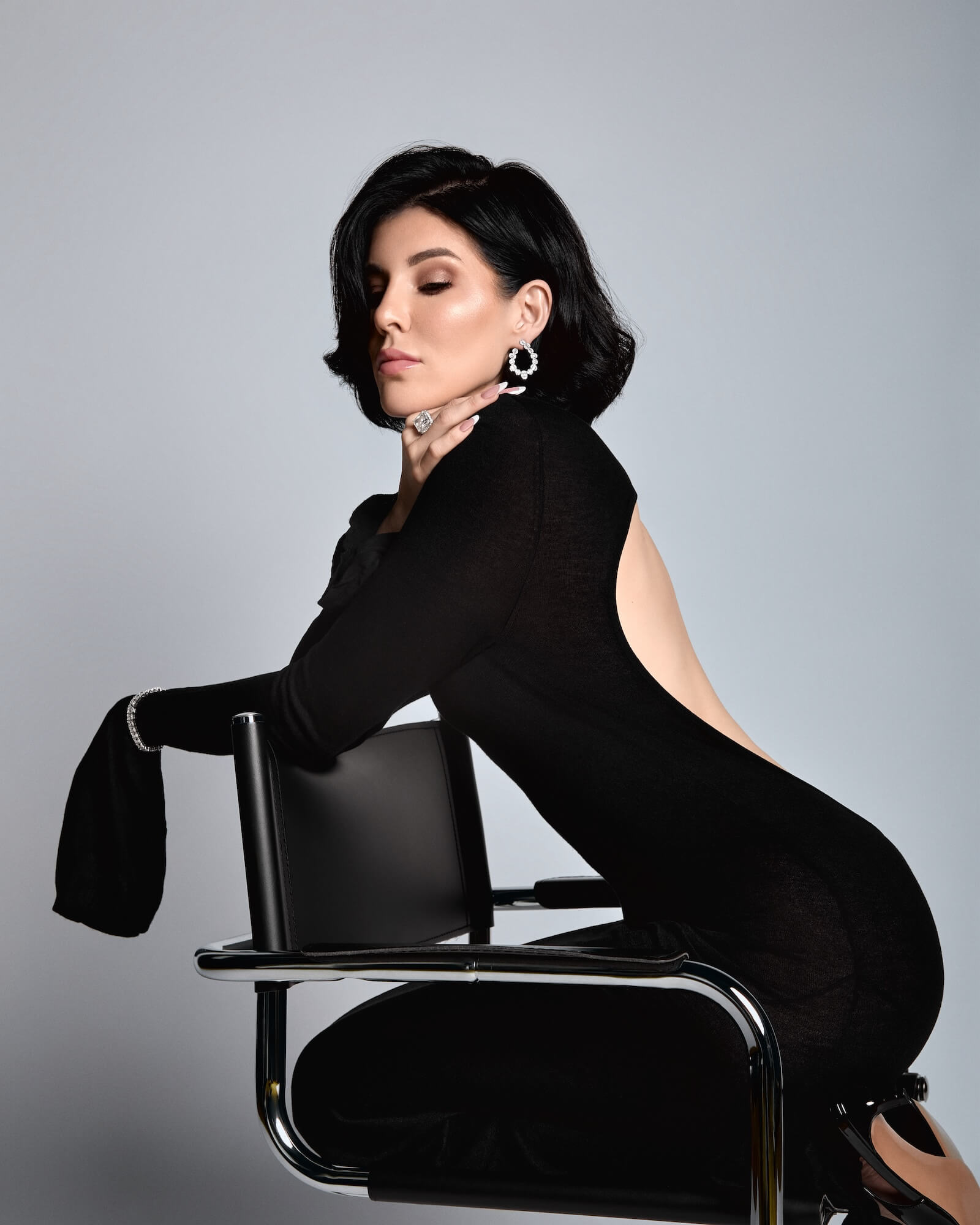 Luxury jewelry designer Viviana Halil wearing her own pair of the Ophelia baguette open hoop earrings in 925 sterling silver.