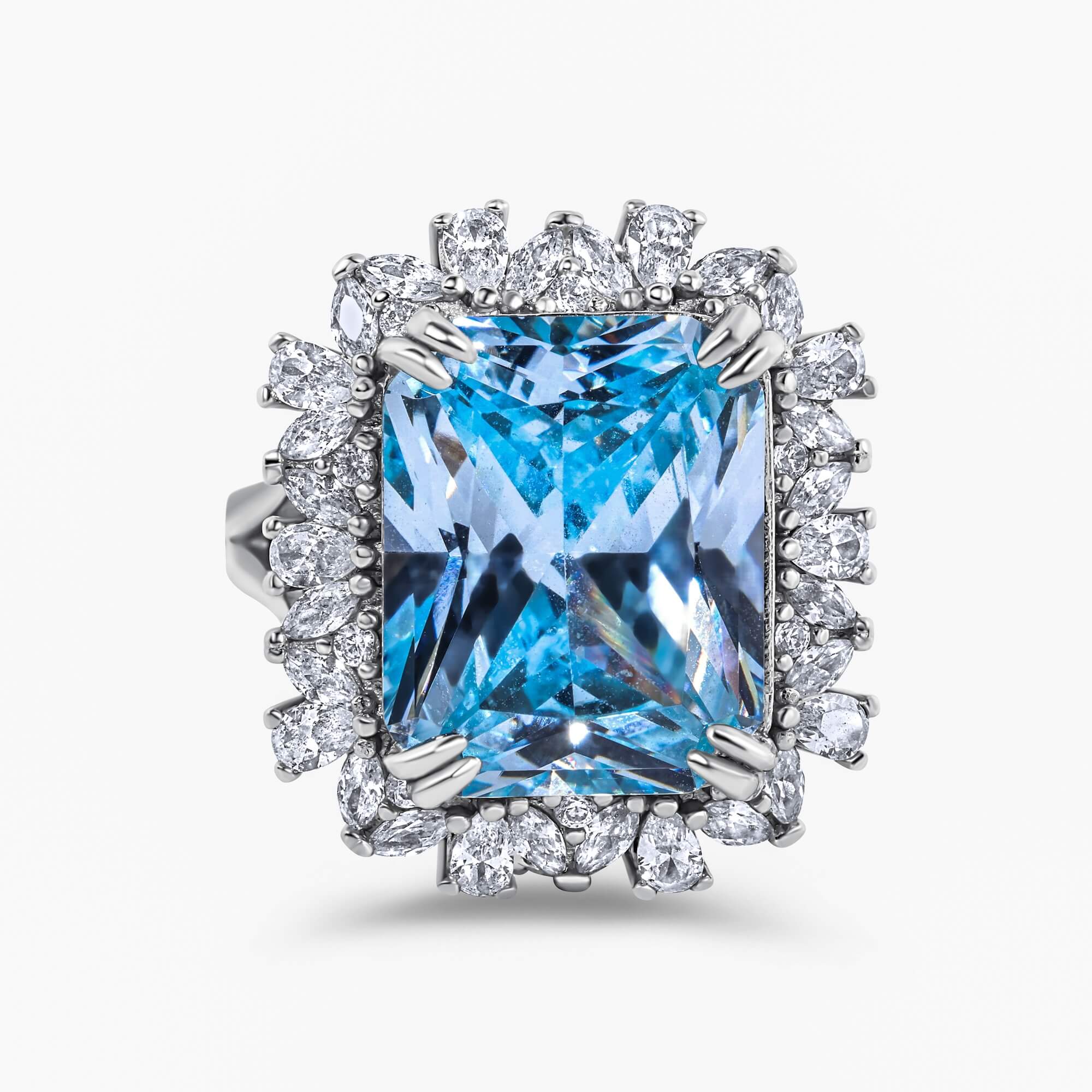 The Sissi Emerald-cut sky blue zirconia cocktail ring with double claw prongs and a mixed halo of round, pear, and marquise-cut stones
