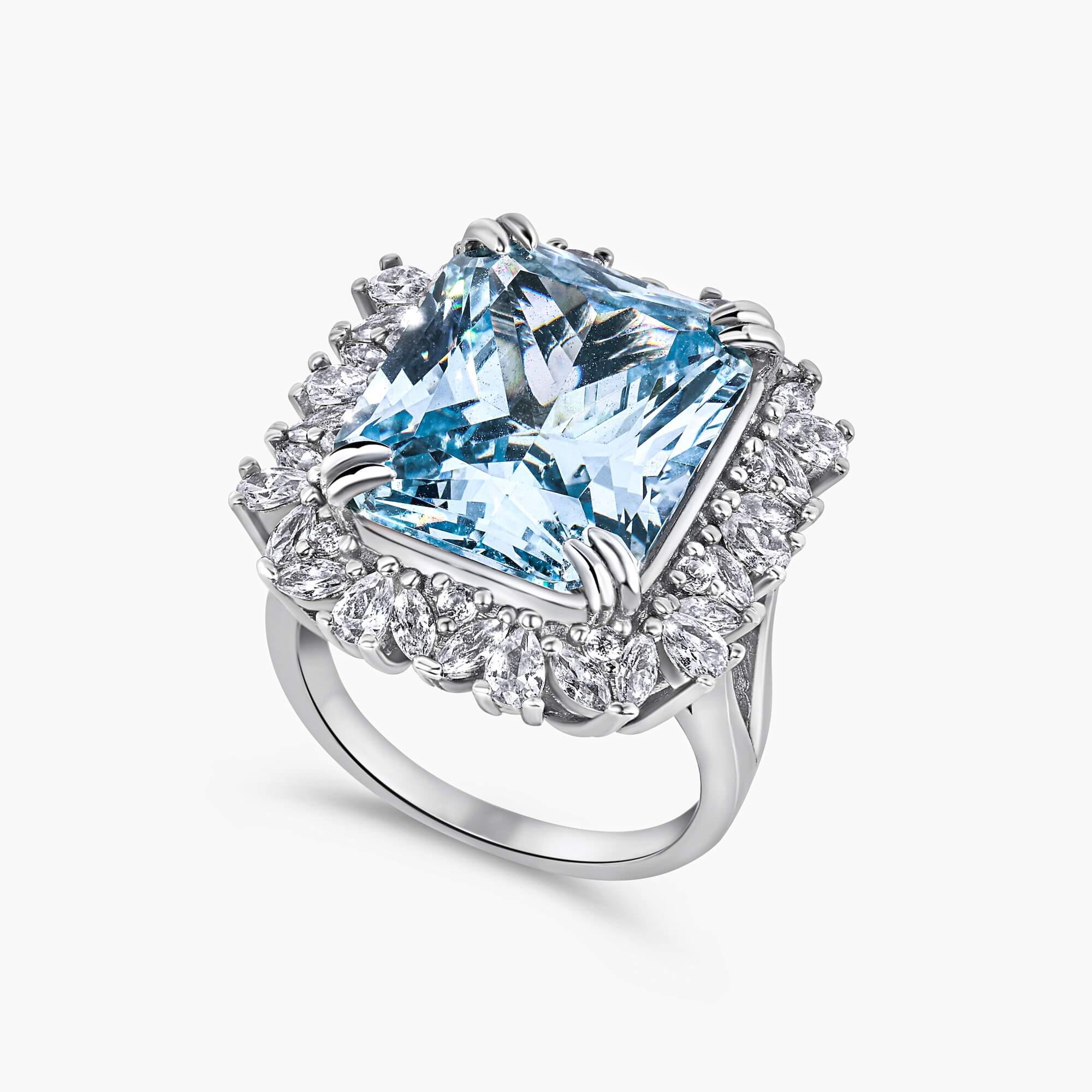 Blue cocktail ring with emerald-cut zirconia, double claw prongs, and a halo of round, pear, and marquise-cut premium stones