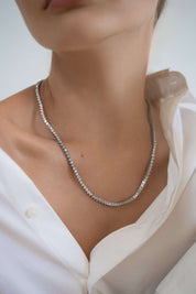 Diamond-free tennis necklace styled on neck — The Soleil by luxury house Viviana Halil.