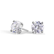 A pair of sterling silver stud earrings featuring round premium zirconia stones with a classic martini design setting.