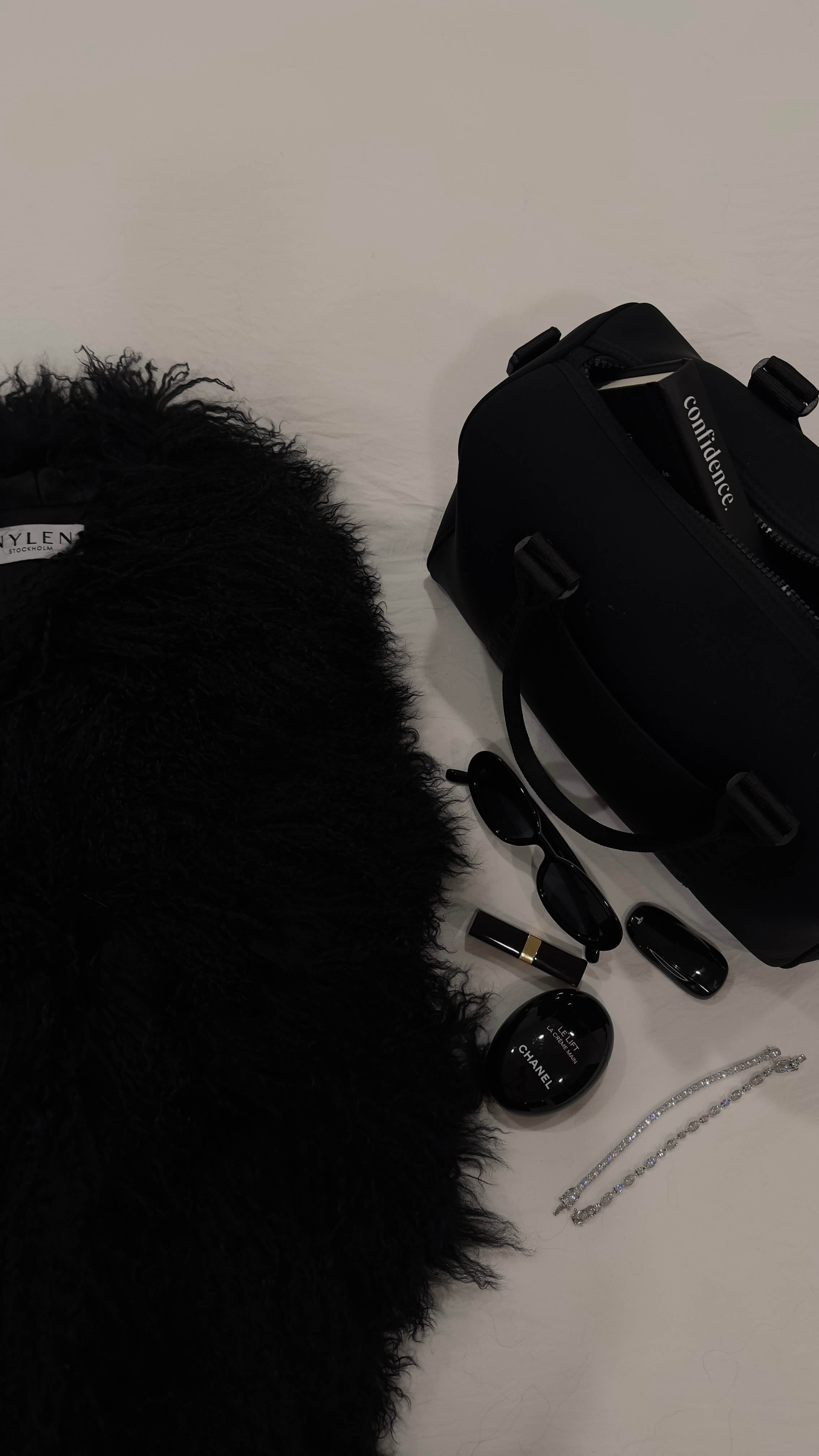 The Yves bracelet by Viviana Halil paired alongside a mongolian fur coat, athleta handbag, chanel handcream and a tesla car key. 