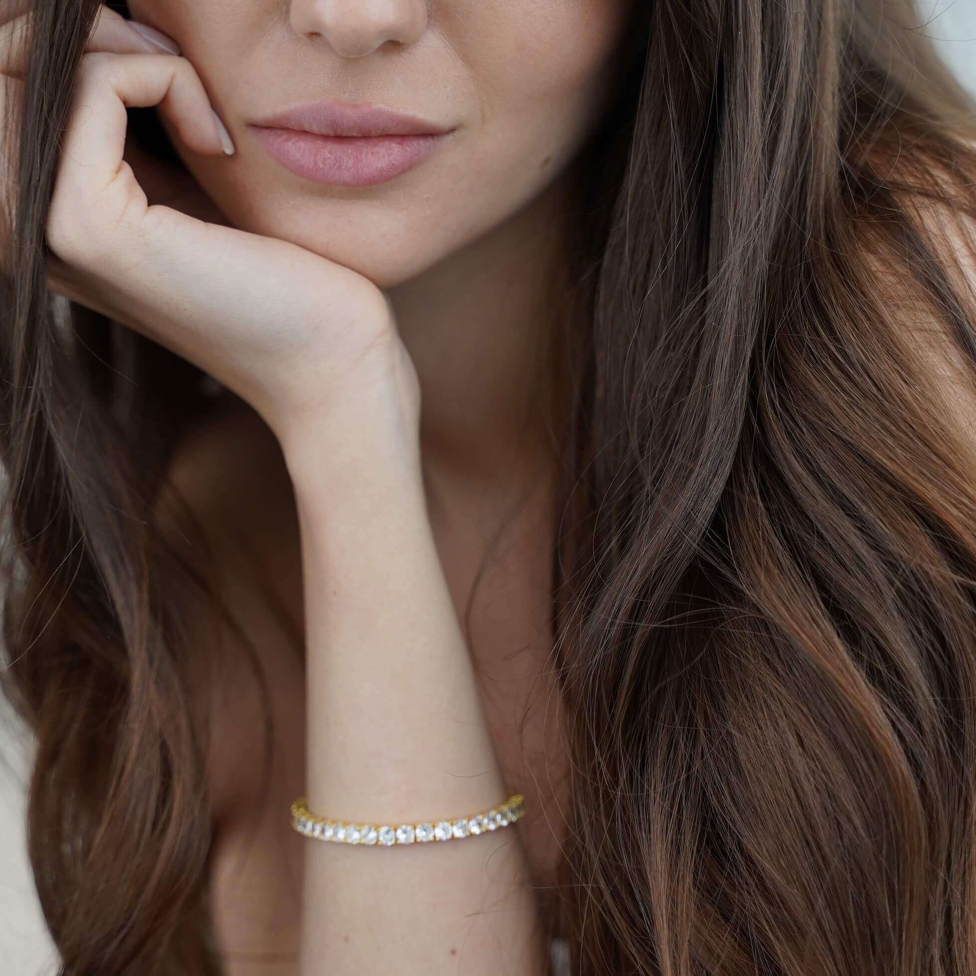 The Luxxe Tenne 4mm diamond simulant tennis bracelet in 18k gold by Viviana Halil.
