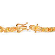 Gold bracelet with yellow gemstones on a white background