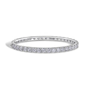 A sterling silver bangle bracelet encrusted with moissanite stones by viviana halil , displayed against a white background