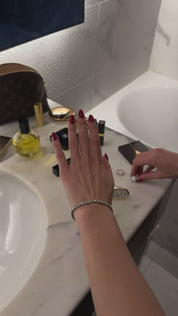 Ellie Wilson adorning her hand with The Mon cheri ring and The petite luxxe tenne bracelet by Viviana Halil.