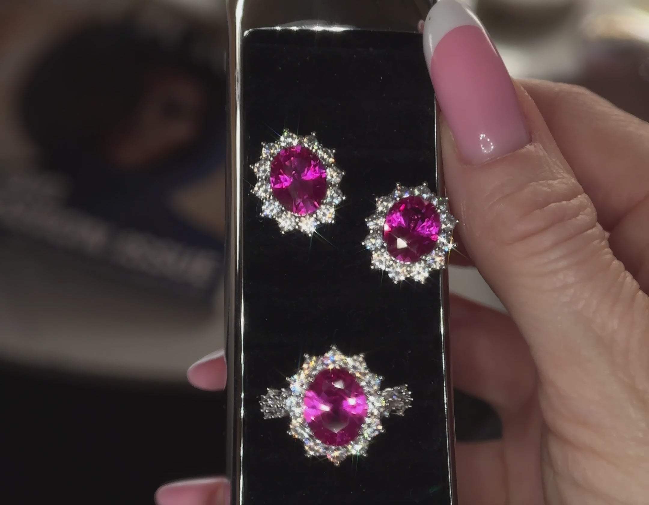 Close-up video of a pair of Lucia oval halo stud earrings and matching Lucia oval pink halo ring, both in premium pink fuchsia VH zirconia by Viviana Halil.