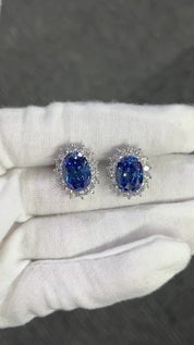 The Princess Diana Earrings crafted using pure sterling silver and set with premium VH zirconia showcased by white glove hand.