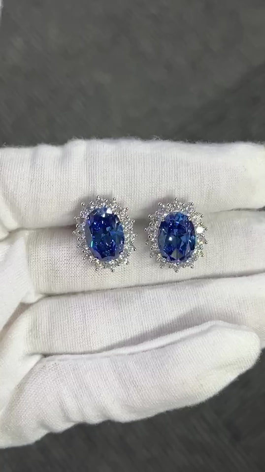 The Princess Diana Earrings crafted using pure sterling silver and set with premium VH zirconia showcased by white glove hand.