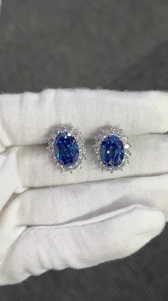 The Princess Diana Earrings crafted using pure sterling silver and set with premium VH zirconia showcased by white glove hand.