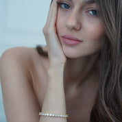 Model wearing The luxxe tenne diamond simulant 18k gold tennis bracelet by Viviana Halil. 
