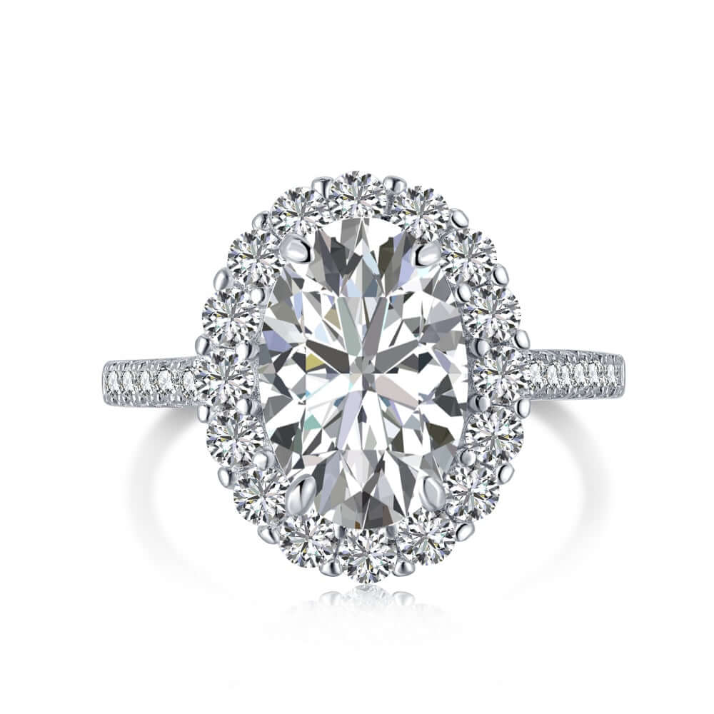 A ring featuring a central oval-cut zirconia stone with round cut stones set in a sterling silver pave band.