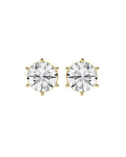 A pair of round-cut stud earrings in moissanite in a six-prong 14k gold setting, shown against a plain white background.
